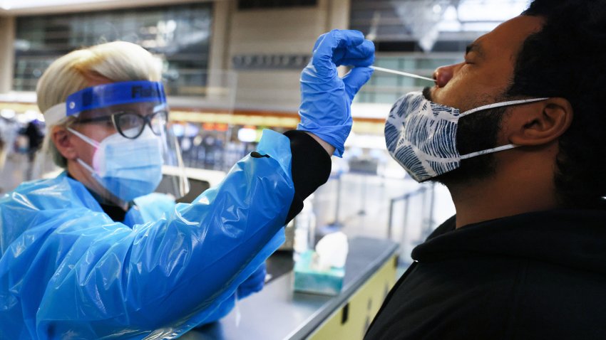 LOS ANGELES, CALIFORNIA – DECEMBER 22: A man receives a nasal swab COVID-19 test at Tom Bradley International Terminal at Los Angeles International Airport (LAX) amid a coronavirus surge in Southern California on December 22, 2020 in Los Angeles, California. The tests are not mandatory with results returned within 24 hours to help travelers avoid quarantining at their destinations. TSA agents screened over 1 million people for three consecutive days last Friday, Saturday and Sunday, the beginning of the traditional holiday travel season, for the first time since the start of the coronavirus pandemic. (Photo by Mario Tama/Getty Images)