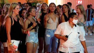 Grupo de mujeres jóvenes en ropa de playa durante la noche en Cancún