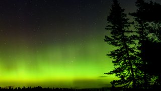 Stock photo of the aurora shining over Moosehead Lake in Maine.