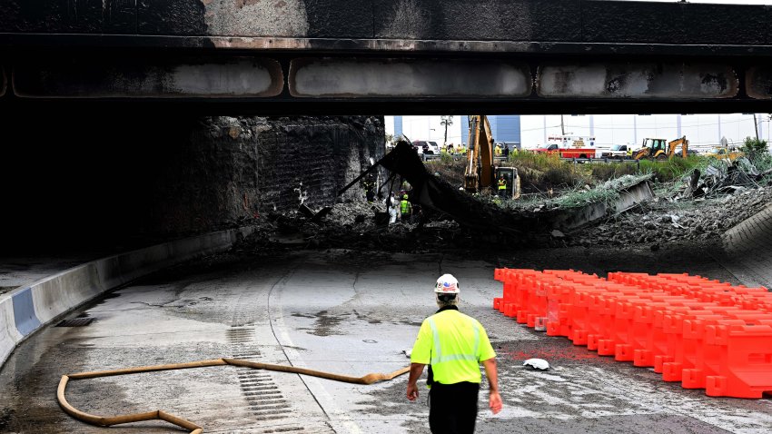 PHILADELPHIA, PENNSYLVANIA – JUNE 12: Workers inspect and clear debris from a section of the bridge that collapsed on Interstate 95 after an oil tanker explosion on June 12, 2023 in Philadelphia, Pennsylvania.  Traffic was severely affected due to the closure of this primary north-to-south highway for East Coast travel. (Photo by Mark Makela/Getty Images)