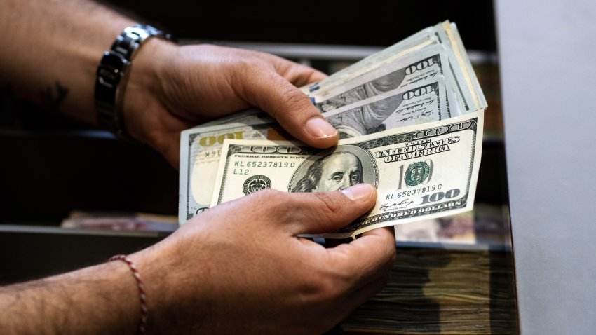 An employee counts US 100 dollar banknotes in Istanbul, Turkey, on Thursday, June 8, 2023. Turkey’s lira plunged to a record low as state-run lenders temporarily halted dollar sales, in a sign the new economic team is abandoning a costly intervention strategy as part of an expected turn toward more conventional policies. Photographer: Moe Zoyari/Bloomberg via Getty Images