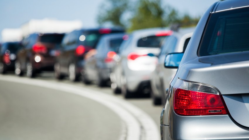 Cars lined up in traffic.