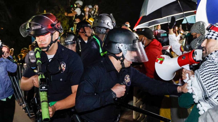 TOPSHOT – Police react while pro-Palestinian students stand their ground after police breached their encampment at the campus of the University of California, Los Angeles (UCLA) in Los Angeles, California, early on May 2, 2024. Police deployed a heavy presence on US university campuses on May 1 after forcibly clearing away some weeks-long protests against Israel’s war with Hamas. Dozens of police cars patrolled at the University of California, Los Angeles campus in response to violent clashes overnight when counter-protesters attacked an encampment of pro-Palestinian students. (Photo by Etienne LAURENT / AFP) (Photo by ETIENNE LAURENT/AFP via Getty Images)