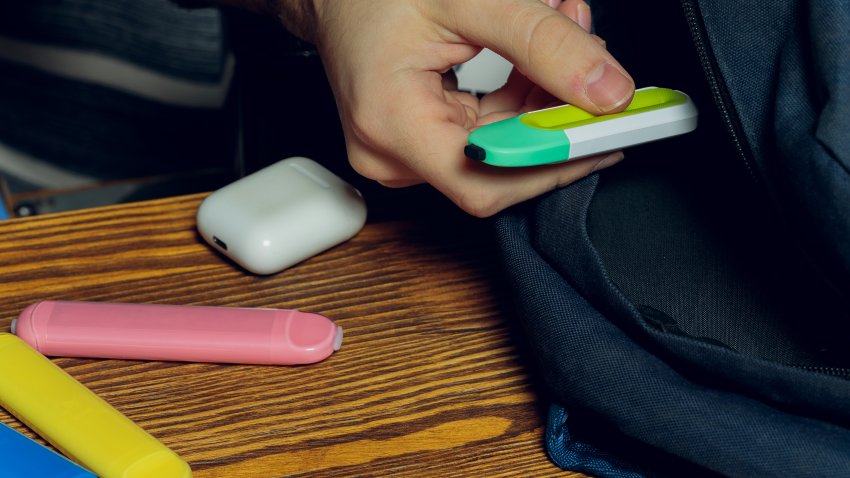 POD e-cigarette or nicotine vapor stick a by school bag