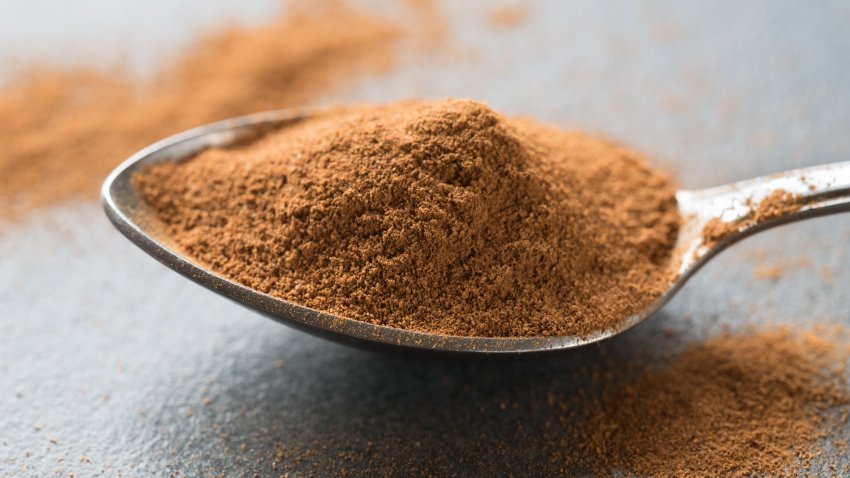 spoon of cinnamon on table macro