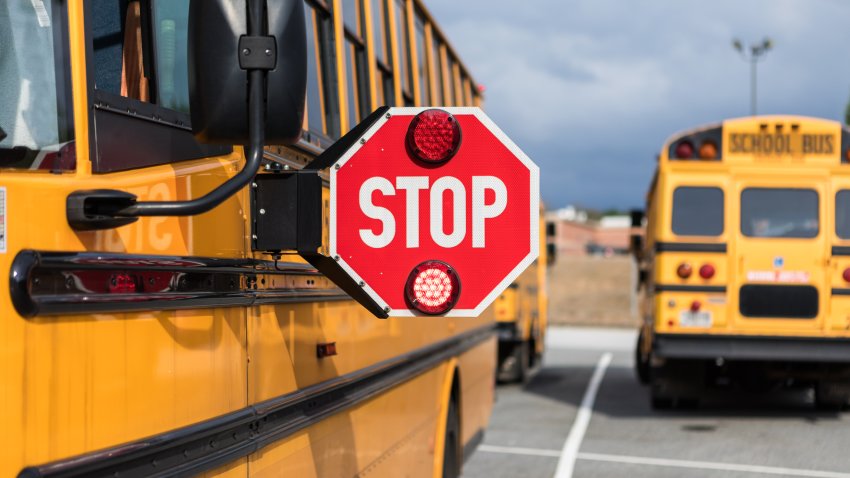 School bus driver checking multiple aspects of the bus before route.