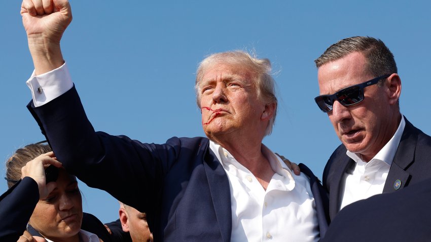 BUTLER, PENNSYLVANIA – JULY 13: Republican presidential candidate former President Donald Trump pumps his fist as he is rushed offstage during a rally on July 13, 2024 in Butler, Pennsylvania. Butler County district attorney Richard Goldinger said the shooter is dead after injuring former U.S. President Donald Trump, killing one audience member and injuring another in the shooting. (Photo by Anna Moneymaker/Getty Images)