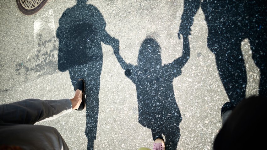 Mother, Father And Son Holding Hands.