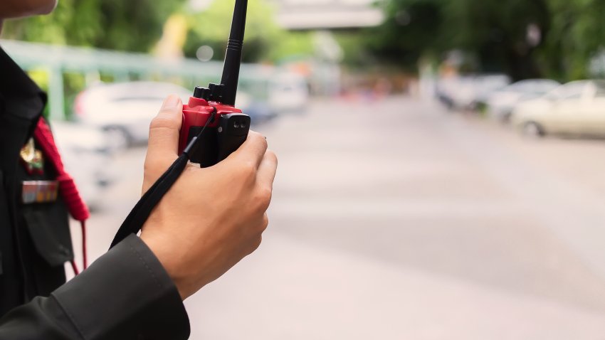 Security guard uses radio communication for facilitate traffic. Traffic Officers use walkie talkie to maintain order in the parking lot in Thailand.