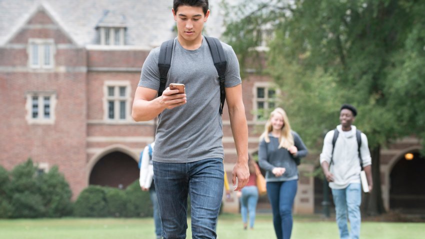 Student texting on college campus