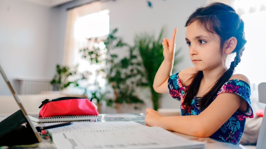 Caucasian preteen girl concentrated on her task with tablet. Concept of distance learning in isolation