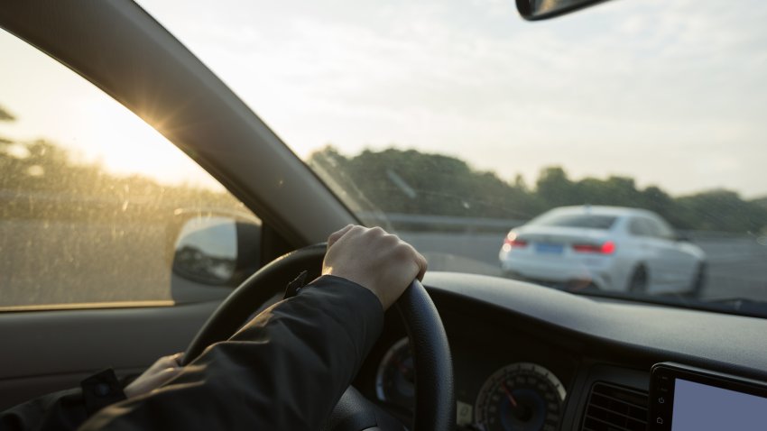 People driving car on sunrise city road