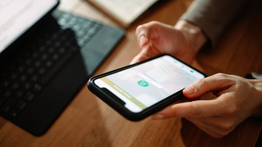 Close up photo of woman hands using digital tablet and smartphone for login to online bank account from home.