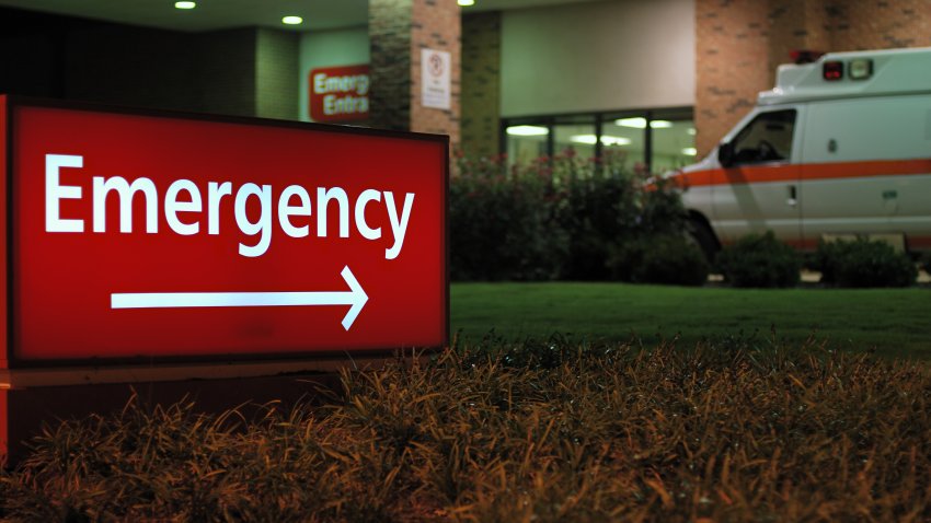 Emergency room entrance at night with ambulance