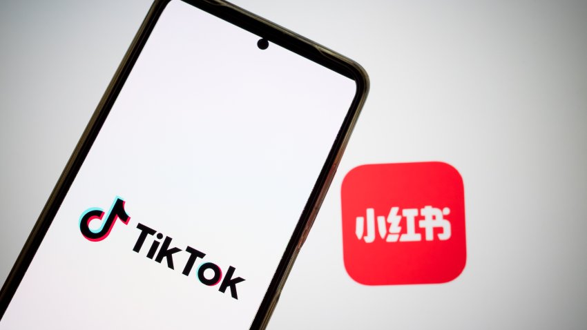 The RedNote logo appears on a smartphone screen, and the TikTok logo appears on a computer screen as the background in this photo illustration in Athens, Greece, on January 15, 2025. TikTok users in the US migrate to a Chinese app called RedNote with the threat of a ban just days away. (Photo Illustration by Nikolas Kokovlis/NurPhoto via Getty Images)