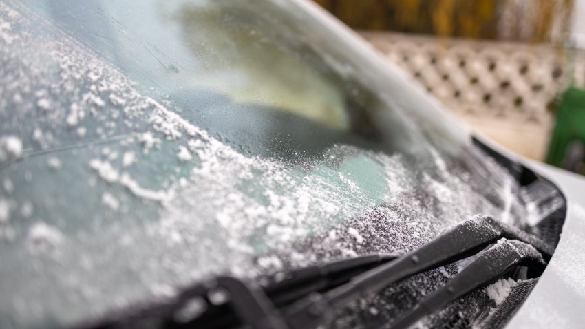 Frost on a car. Close-up of frost on car windshield. Driving in winter season concept