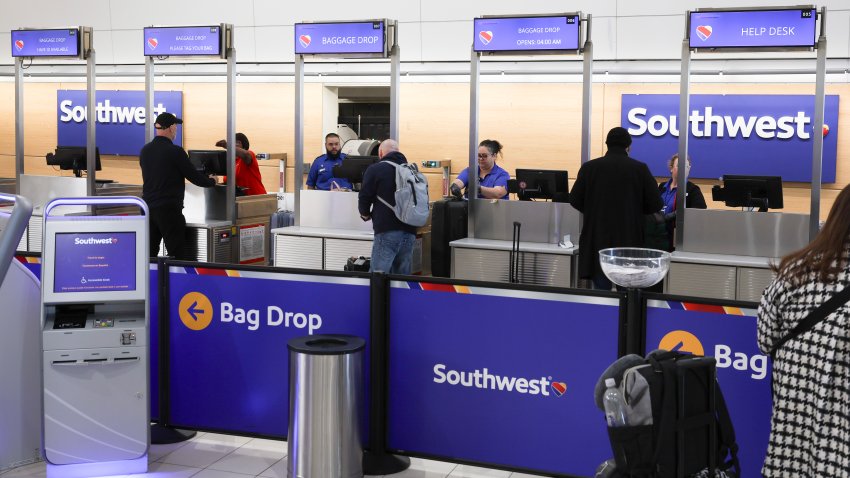 ARLINGTON, VIRGINIA – JANUARY 30: Travelers stand at the Southwest Airlines counter at Reagan National Airport after an American Airlines plane crashed on approach to the airport on January 30, 2025 in Arlington, Virginia. The American Airlines flight from Wichita, Kansas collided with a military helicopter while approaching Ronald Reagan National Airport. According to reports, there were no survivors amongst the 67 people on board both aircraft. (Photo by Tasos Katopodis/Getty Images)