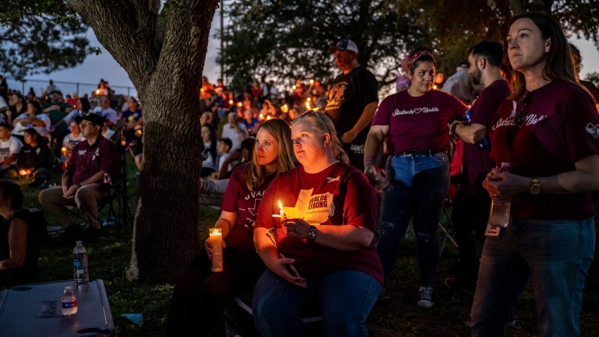 UVALDE, TX-MAY 24: Community members listen to a performance during a vigil at the Uvalde Ampitheater on Wednesday, May 24, 2023 in Uvalde, TX. The community gathered to remember those that were lost in a shooting last year at Robb Elementary that took the lives of 19 students and 2 teachers. (Sergio Flores for The Washington Post via Getty Images)