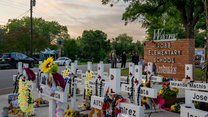 UVALDE, TEXAS – MAY 24: Law enforcement stand watch near a memorial dedicated to the 19 children and two adults murdered on May 24, 2022 during the mass shooting at Robb Elementary School on May 24, 2023 in Uvalde, Texas. Today marks the 1-year anniversary of the mass shooting at the school. 19 children and two teachers were killed when a gunman entered the school, opening fire on students and faculty. (Photo by Brandon Bell/Getty Images)