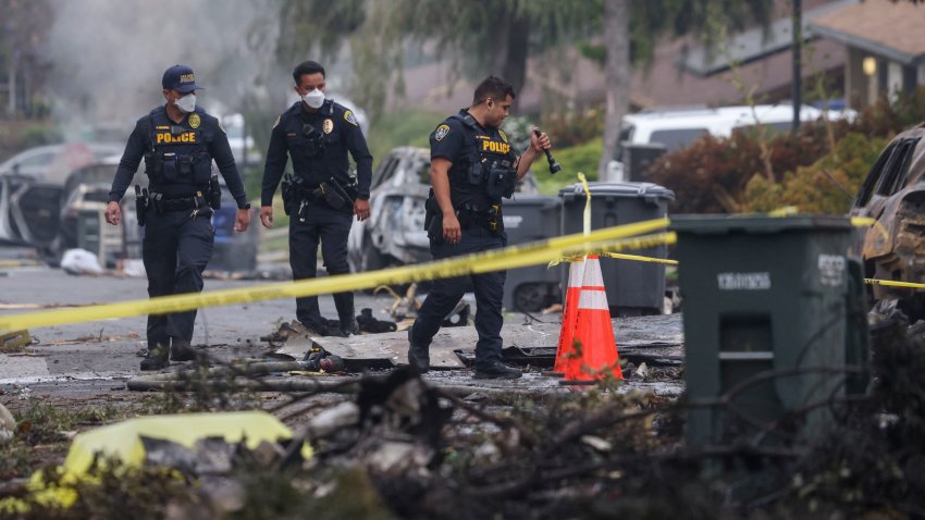 Investigators look through the site where a small plane crashed into a San Diego, California, residential street on May 22, 2025. The Federal Aviation Authority said a Cessna 550 crashed at around 3:45 am local time. The neighborhood is close to the Montgomery-Gibbs Executive Airport. The crash left a "gigantic debris field" and damaged some 15 homes and parked cars, ABC News quoted the San Diego assistant fire chief as saying. (Photo by Sandy Huffaker / AFP) (Photo by SANDY HUFFAKER/AFP via Getty Images)