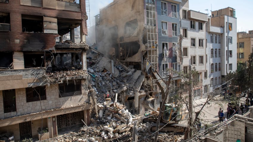 TEHRAN, IRAN – JUNE 13: An excavator removes debris from a residential building that was destroyed in today’s attack by Israel in Tehran, on June 13, 2025 in Tehran, Iran. Early this morning, Iran was hit by a series of Israeli airstrikes targeting military and nuclear sites, as well as top military officials. (Photo by Majid Saeedi/Getty Images)