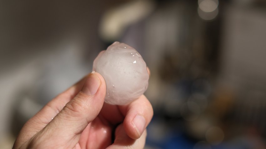 Heavy rain with large hail grains in urban landscape with apartments and outdoor garden Weather alert for strong hailstorm in the centre of Milan on the evening of July 12, 2024