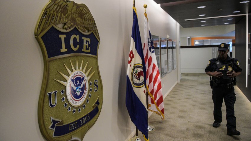WASHINGTON, DC – MAY 11: A law enforcement officer walks past ICE logo ahead of a press conference on Thursday, May 11, 2017, at the U.S. Immigration and Customs Enforcement  headquarters in Washington, DC. (Photo by Salwan Georges/The Washington Post via Getty Images)
