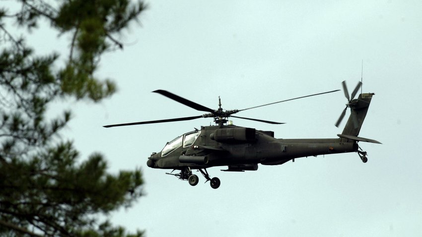 BRONSON, TX – FEBRUARY 5:  An Apache helicopter flies over a wooded field while searching for remnants of the space shuttle Columbia February 5, 2003 in Bronson, Texas.  Any found debris is being reassembled for an investigation into the cause of the crash.  (Photo by Ronald Martinez/Getty Images)