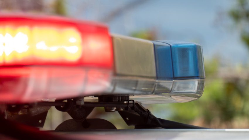The emergency lights on a police vehicle of the New South Wales Police Force parked at the corner of Carrington Road and Pine Street, Randwick, at the scene of a motor vehicle accident.  This image was taken on a hot and sunny morning on 8 February 2025.