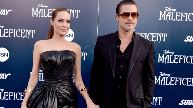 Pegan a Brad Pitt en estreno "Maleficent"